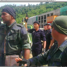 Shooting guns.  Armed Police have surrounded and at times terrorised the Penan blockaders by shooting above their heads.
