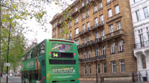 The advertising bus passes in front of Taib's Hyde Park mansion.