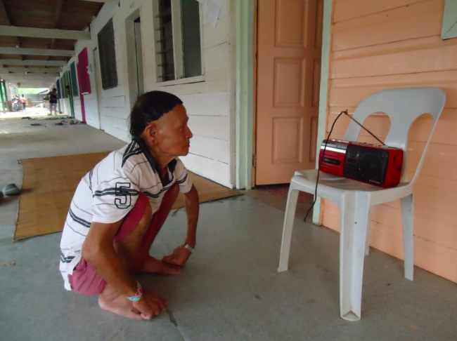 A native Penan listens to the show.