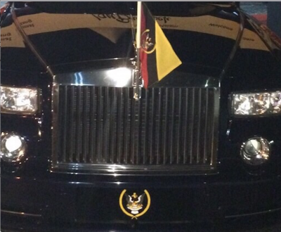 Clearly illustrious Taib needs no number plate - a flag and emblem will do ...