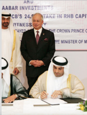 Khadem signs the deal while Najib looks on - but where did all the money go from the 1MDB/Aabar "strategic partnership"?